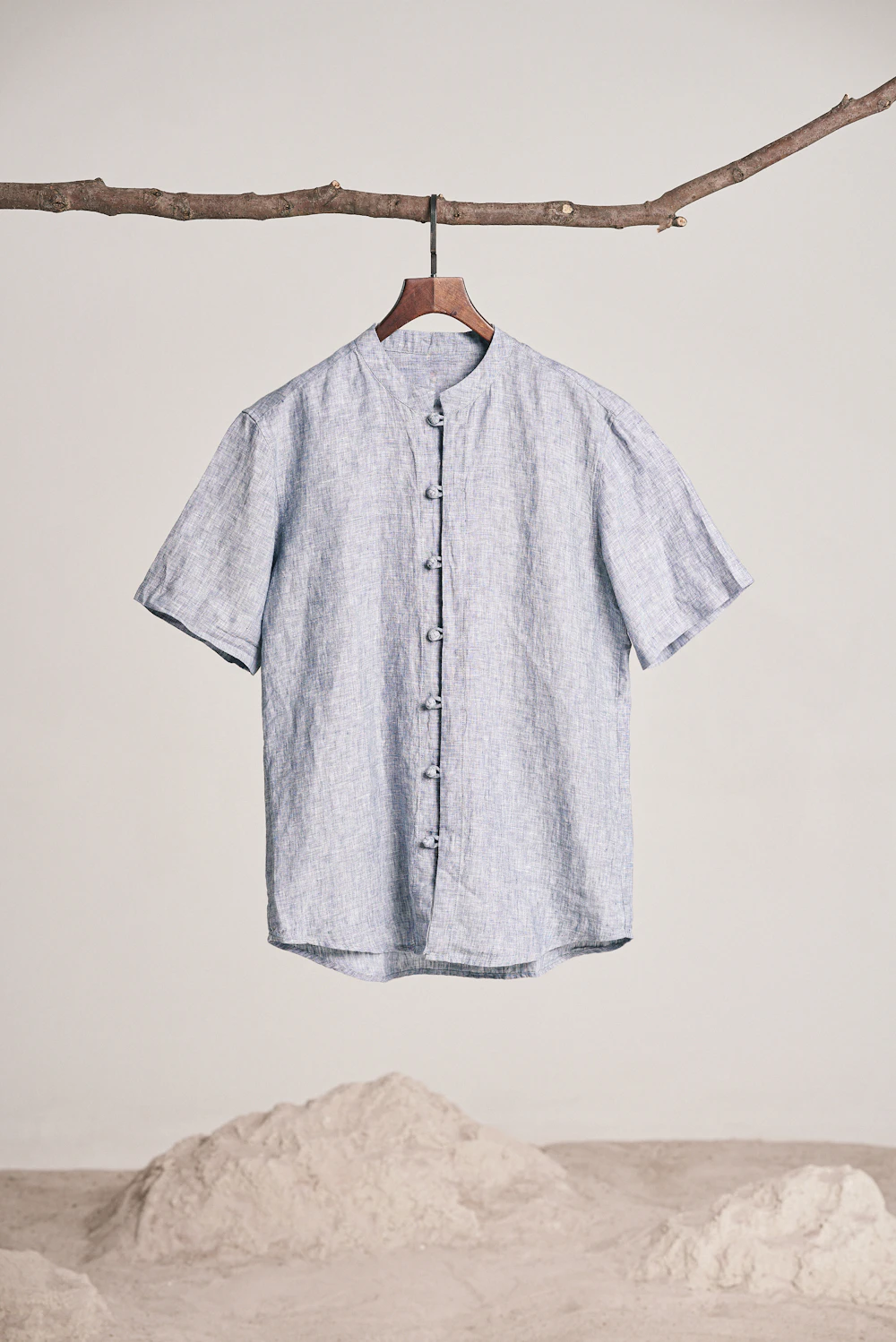 Blue linen shirt on a wooden hanger