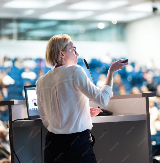 Speaker presenting to a conference audience