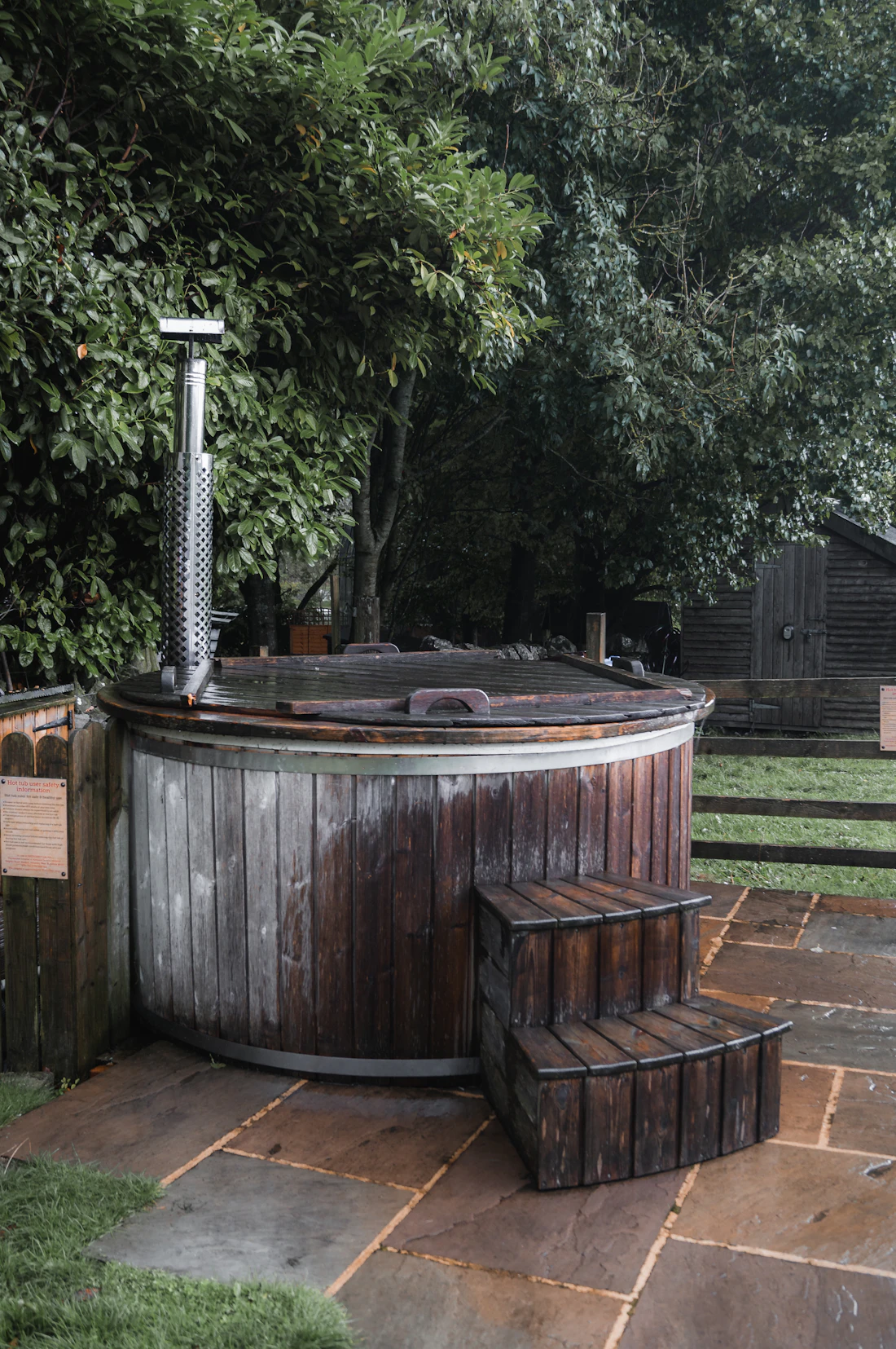 A round wooden hot tub in the forest