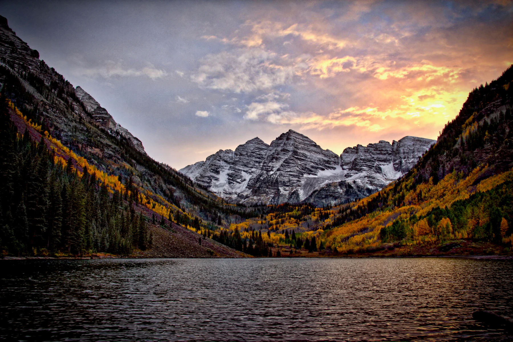 Maroon Bells at sunset with a still lake in front