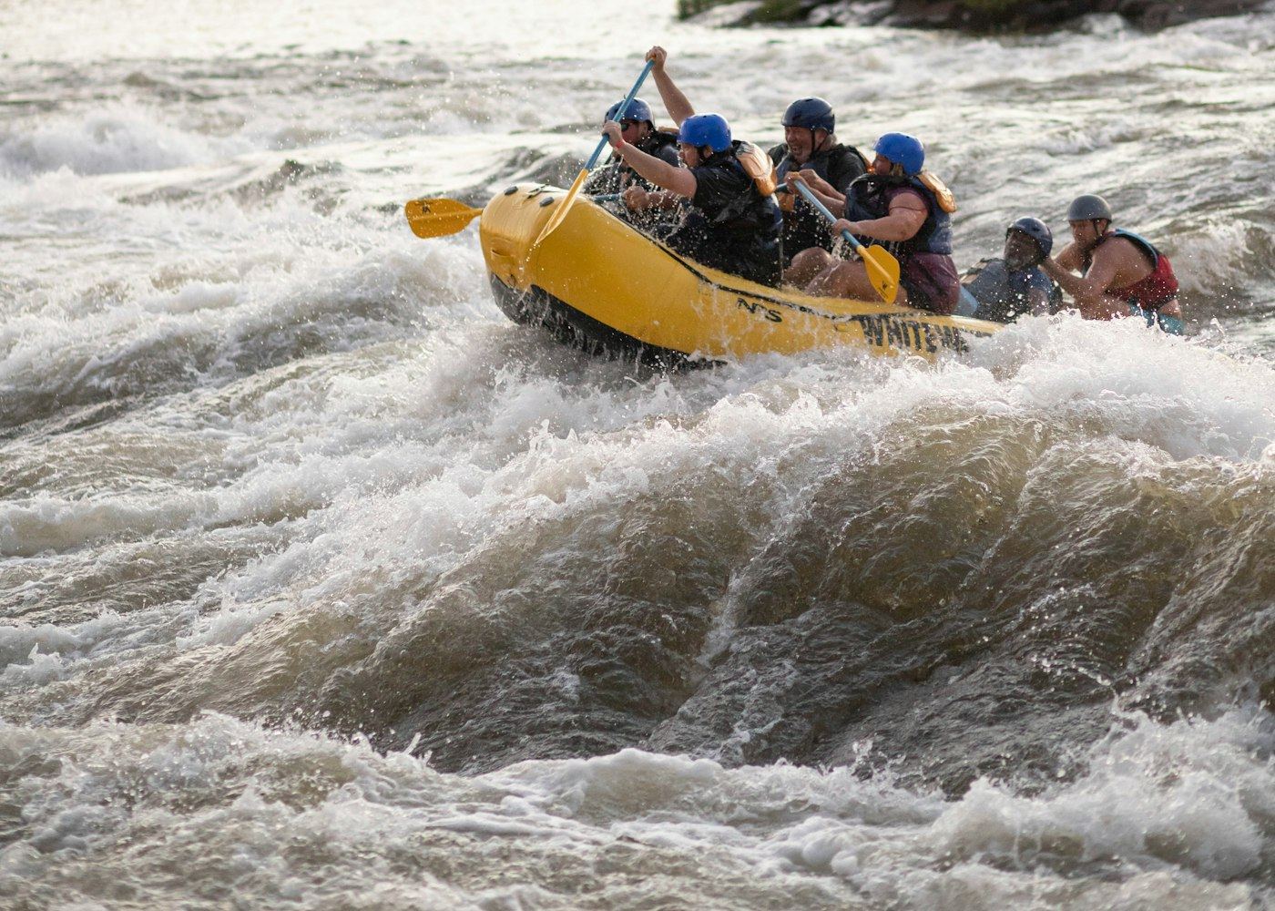 Raft crew paddling into evening light