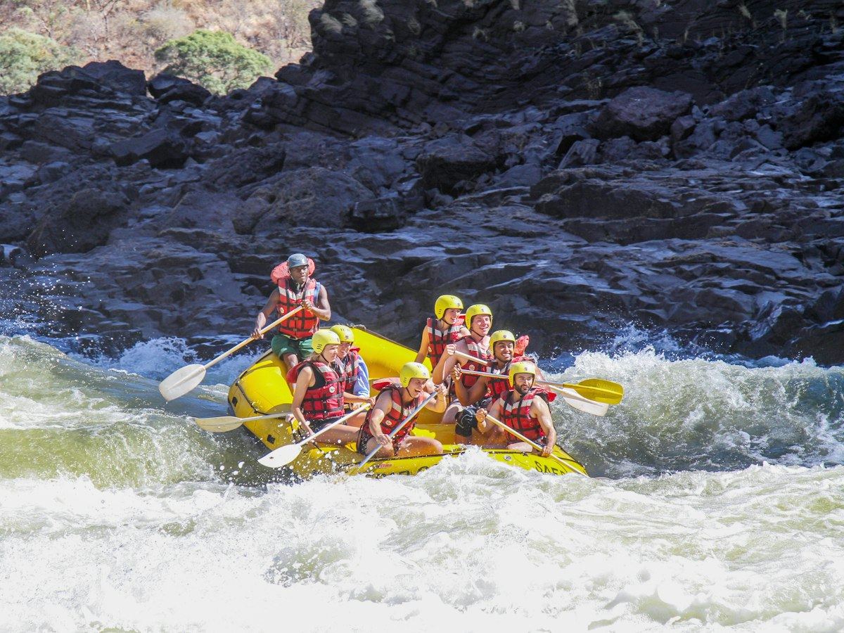 Yellow raft working through a rocky rapid